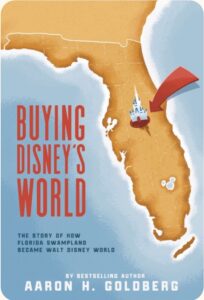 The copy of the book Buying Disney's World by Aaron H. Goldberg. It is an map of Florida with a large red arrow pointing to Cinderella Castle in the middle of the state.