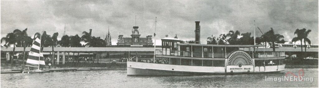 The Southern Seas steamship, a catamaran with a striped sail, and a monorail at the dock to the Magic Kingdom.